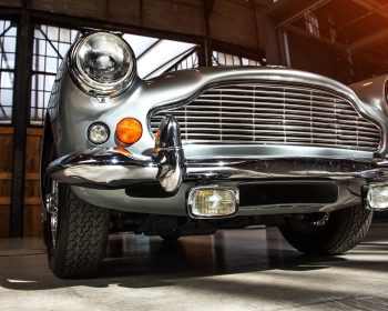 closeup of the headlights and front bumper on a vintage automobile.